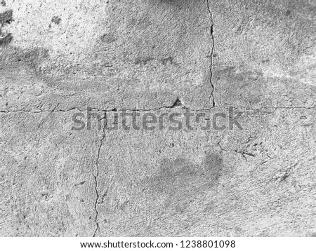Black and white cracked cement ground background and pattern. It rough texture vintage wallpaper material