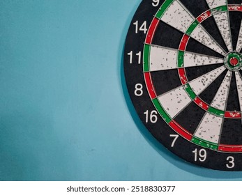 black and white dartboard on the wall. filled with holes where darts stuck. dartboard photo taken at good camera angle and lighting - Powered by Shutterstock