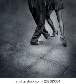 Black and white detail image of a couple dancing tango on the street in Argentina.