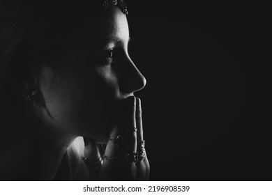 Black And White Dramatic Profile Portrait Of A Young Pensive Woman With Many Rings On Her Fingers. Portrait In A Low Key.