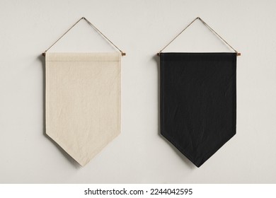 Black and white empty pennant flags on white background. Triangle flags hanging on wall. 
