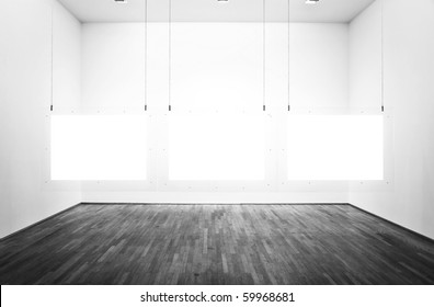 Black & white exhibition room with three pictures and white background