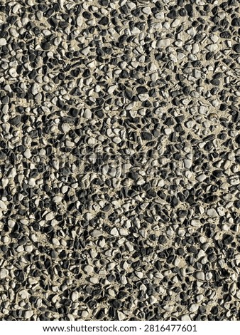 Black and white exposed aggregate pebble wash floor texture background with small gravel stones
