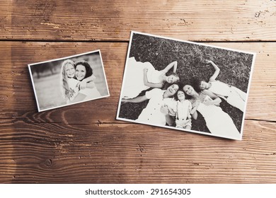 Black and white family photos laid on wooden floor background. - Shutterstock ID 291654305
