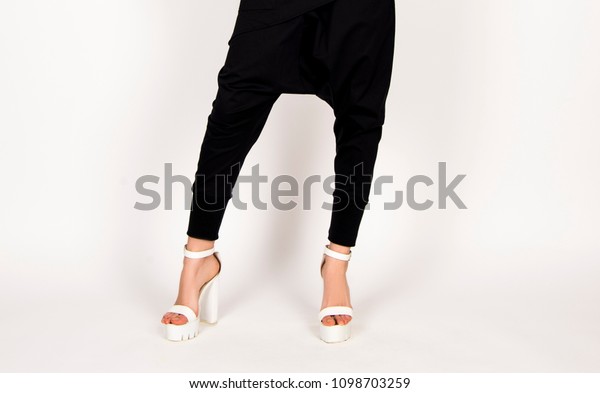 black\
and white fashion concept, harem pants, white high heels, modern\
classy stylish business  look, fashion model\
posing