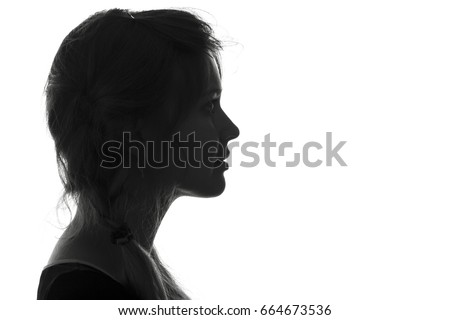 Black and white fashion portrait profile silhouette of face of a beautiful young girl with a hairstyle on her head