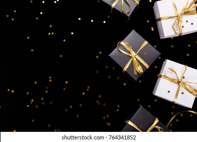 Black And White Gift Boxes With Gold Ribbon On Shine Background. Flat Lay. Copy Space