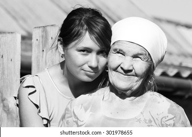 Black And White Grandmother In A Scarf With Her Granddaughter