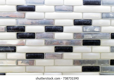 Black White And Gray Glass Tile Backsplash In A Kitchen