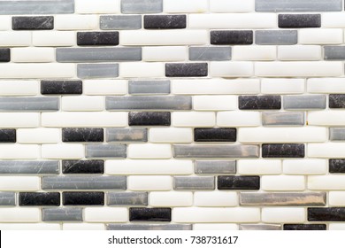 Black White And Gray Glass Tile Backsplash In A Kitchen