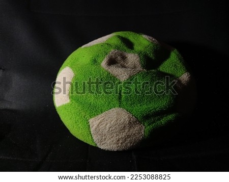 black and white green ball doll