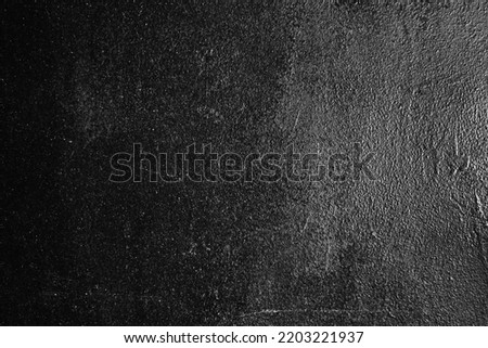 Black white grunge texture. Dark gray background with a light spot. Space for design. Old rough painted metal surface. Close-up.