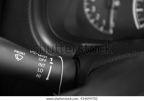 Black and\
white handle of the car computer\
control