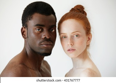 Black And White. Headshot Of African Man And Caucasian Woman Standing Shirtless And Looking At The Camera With Serious Expression. Portrait Of Young Beautiful Interracial Couple. Mixed Race Relations