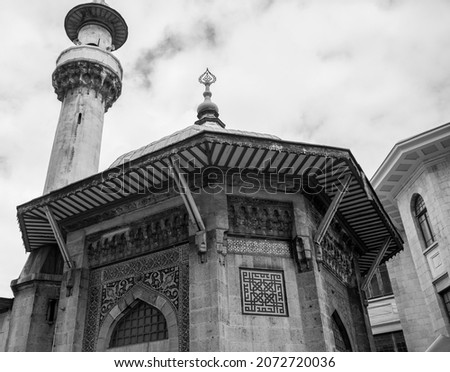 Black and white historical mosque. Hobyar Mosque or Great Postoffice Mosque in Sirkeci, İstanbul. Minaret and octagonal dome. Different mosque design.