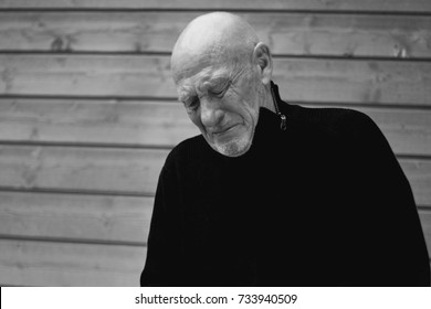 
Black And White Horizontal Capture Of Handsome Crying Senior Expressing Pain Of Loss, Closing Eyes From Suffer. Old Senior Man Closeup Portrait. People, Feelings, Human Concept.