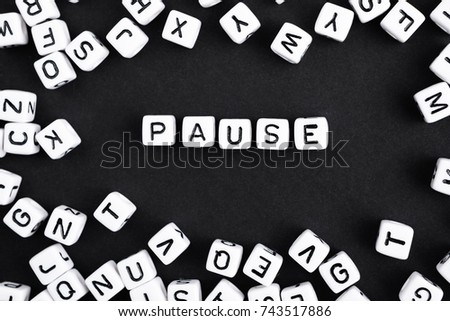 Black and white horizontal composition. Word Pause made of plastic cube.  A series of minimalism phrases and words. 