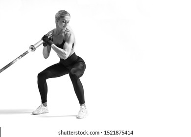 Black and white horizontal photo of hamstring, quad and booty workout Attractive fitness model exercises with barbell row Sporty woman on white background Free copy text space  - Powered by Shutterstock