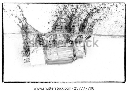 Black and white image , with borders of a electronic vacuum tube valve fall in water with big splash and white background