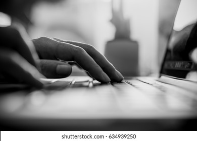 Black And White Image Of A Business Woman's Hands Working And Typing On Laptop Keyboard In Office