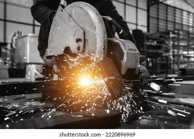 Black And White Image. Construction Worker Uses Steel Cutting Tools In Work Area.