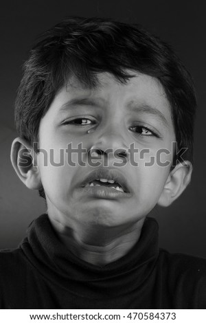 Black and white image of a crying boy