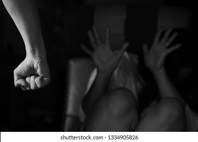 Black and white image of Man beating up his wife illustrating domestic violence