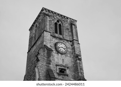 Black and white image of old English church clock tower. Remains of historic stone church  - Powered by Shutterstock