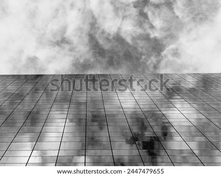 
Black and white image reflecting the shadow of the sun on the glass of the building