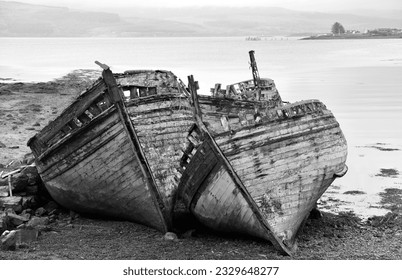 Black and white image of ship wrecks on a beach - Shutterstock ID 2329648277