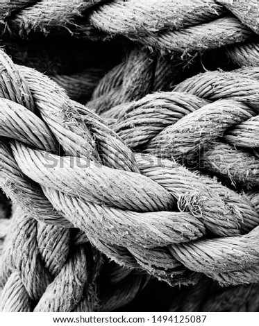 Black & white image of thick rope, taken in close up. Used by fisherman on their boats. Highly textured.                 