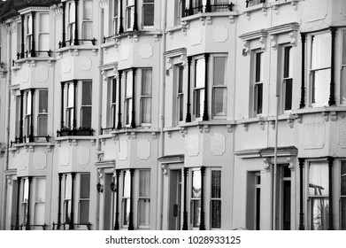 Black And White Image Of Victorian Style Windows With Reflections.