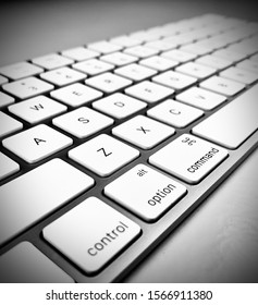 Black and white keyboard on a white surface with bokeh