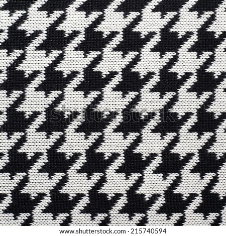 Black and white knitted Houndstooth pattern cloth material fragment as a background texture composition