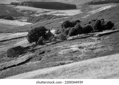 Black And White Landscape Image Of Abandoned Derelict Farm Buildings In Peak District England