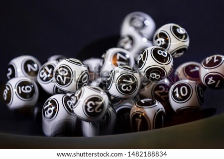 Black and white lottery balls in a bingo machine. Lottery balls in a sphere in motion. Gambling machine and euqipment. Number 13
