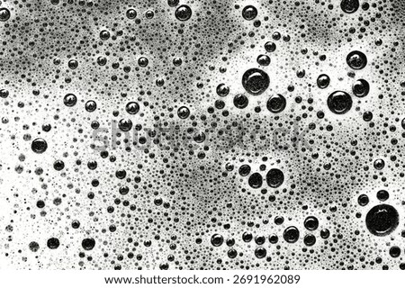 Black and white macro texture of bubbles and foam. Abstract surface background. Soap and water chemical reaction pattern. Artistic detail for modern creative design.