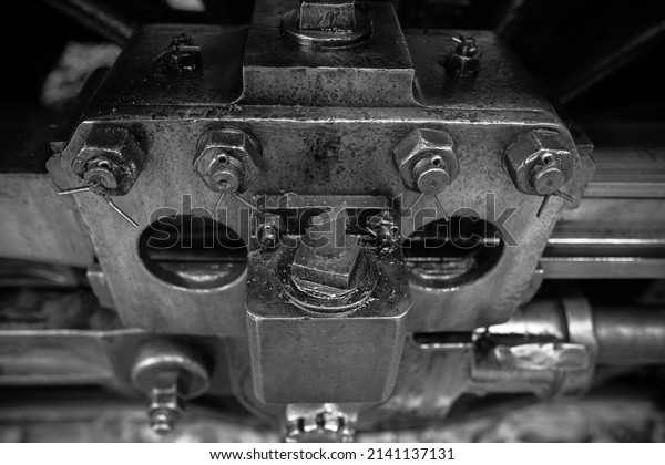 Black and white Metal parts, nuts,\
metal rods filled with oil and dust of steam\
locomotives