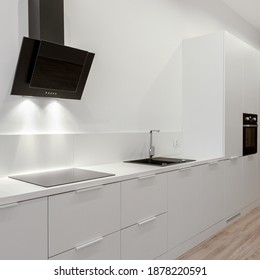Black and white minimalist and stylish kitchen with wooden floor and nice led lighting