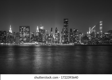 Black and White Monochromatic image of New York City Cityscape during Night Time with busy skyline and dense skyscrapers filling up the sky - Shutterstock ID 1722393640