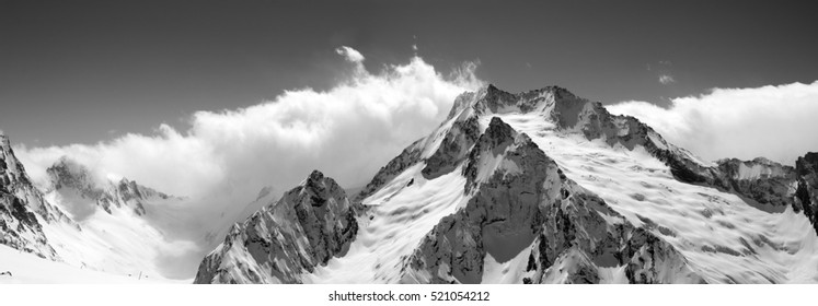 Black and white mountain panorama in clouds. Caucasus, region Dombay. View from the ski slope. 