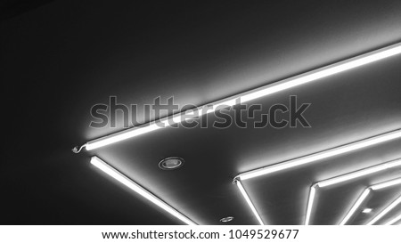 Black and white of neon lighting decoration under gypsum false ceiling. Neon light bulb linear type illuminated background