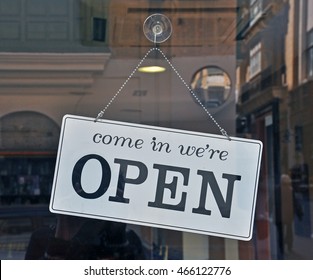 Black And White Open Sign Hanging On The Door