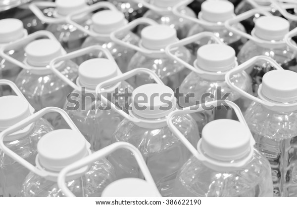 Black and white pack of\
bottles in row 