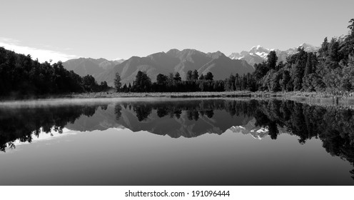 Black & White Panorama of the  Beautiful Lake Matheson, Southern New Zealand. The early morning stillness allows for the perfect reflection.