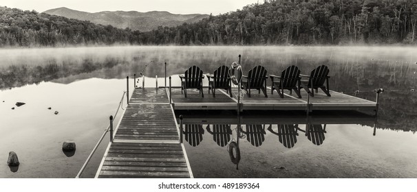 Black & white panorama of the Heart Lake dock on a misty morning in the High Peaks region of the Adirondack Mountains near Lake Placid, NY