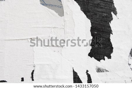 black white patches of torn ripped frayed street posters, creative paper background concept