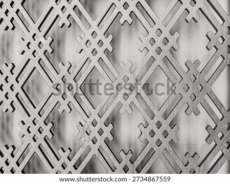 black and white pattern with repeating geometric design.