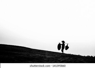 Black and white, people carrying things.
