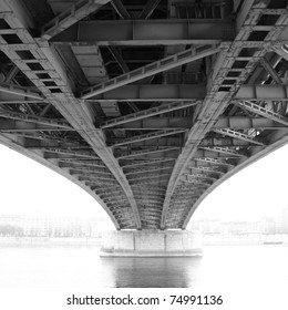 Black And White Photo Of An Abstract Steel Construction From Under The Bridge